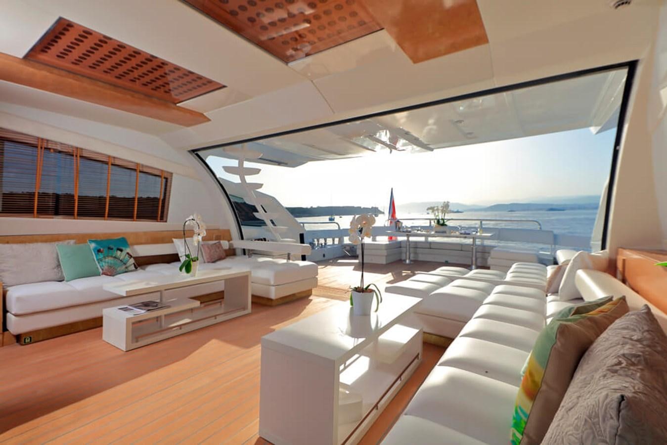 a room with a view of the ocean and the deck aboard BAIA 100 Yacht for Sale