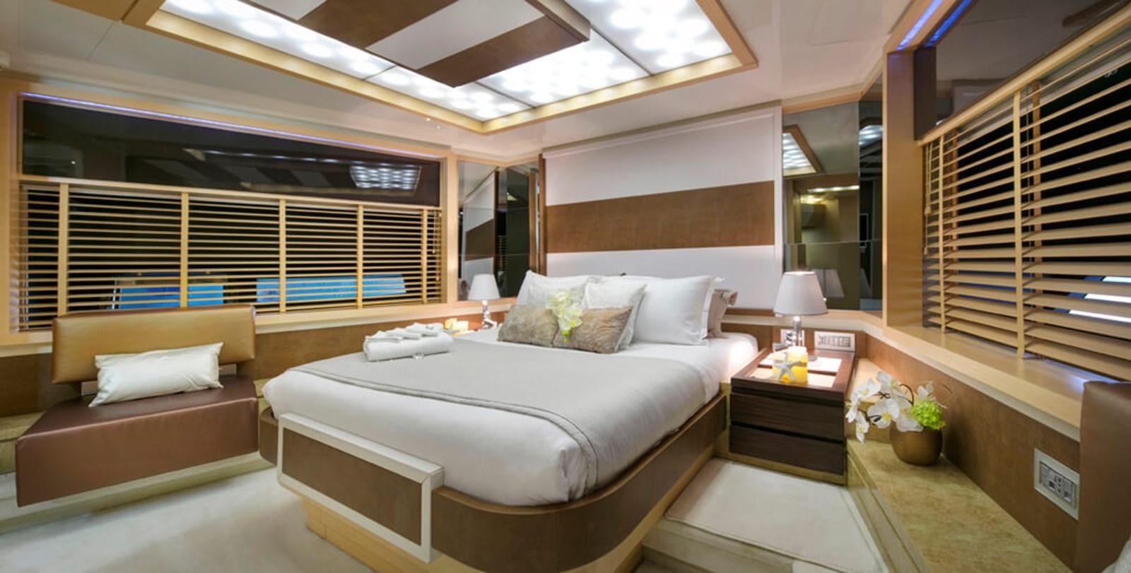 a room with a bed and a couch aboard BAIA 100 Yacht for Sale
