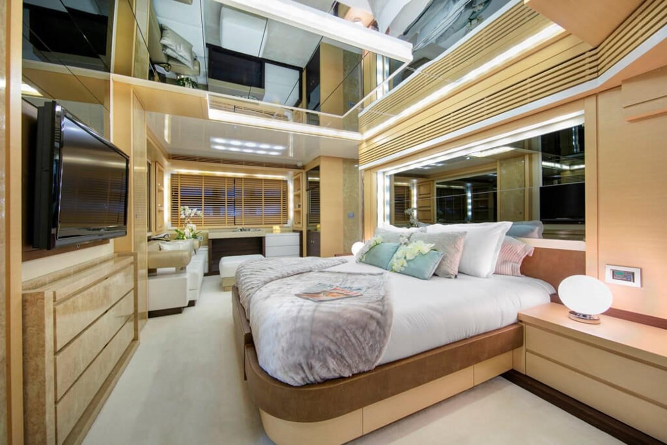 a room with a bed and a tv aboard BAIA 100 Yacht for Sale