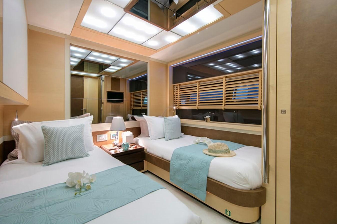 a room with two beds aboard BAIA 100 Yacht for Sale