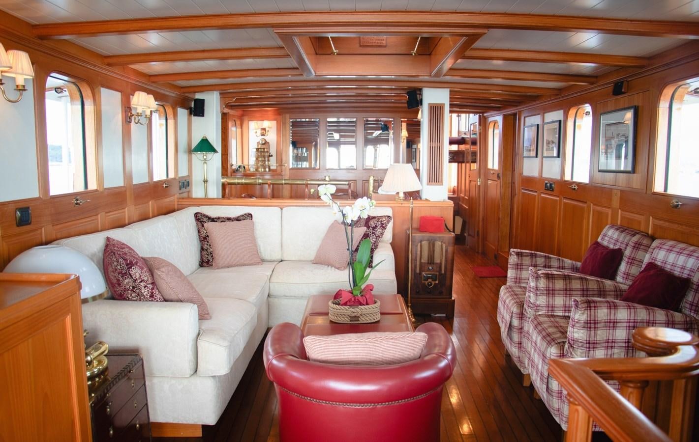 a living room with a couch and a table aboard LADY HERTHA Yacht for Sale