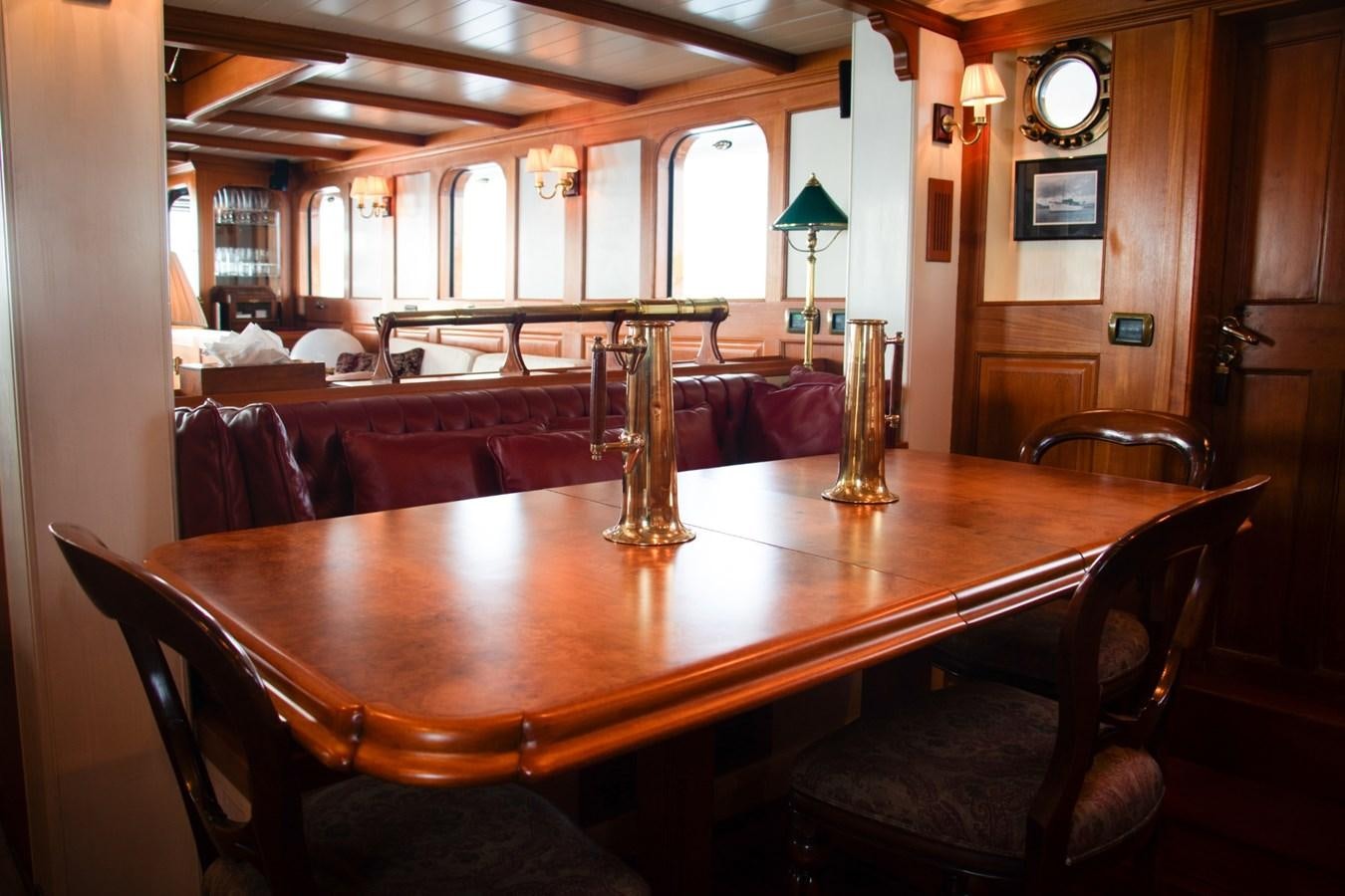 a large wooden table with chairs around it aboard LADY HERTHA Yacht for Sale