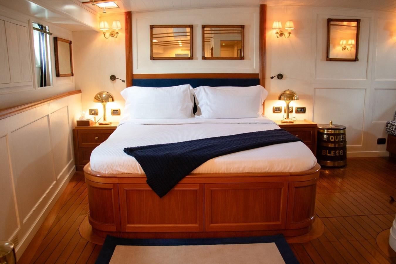 a bed with a blue sheet aboard LADY HERTHA Yacht for Sale