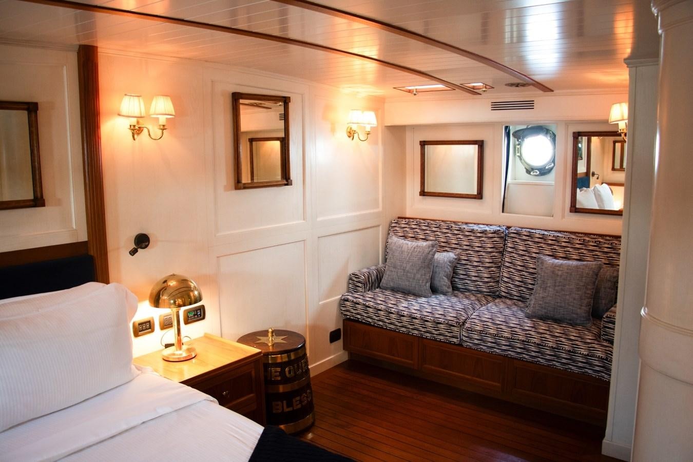 a living room with a couch and a bed aboard LADY HERTHA Yacht for Sale
