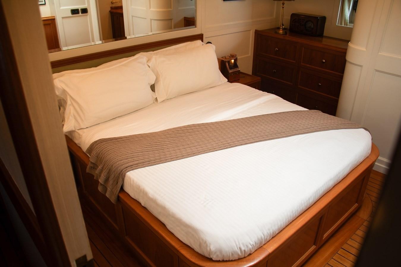 a bed with white sheets aboard LADY HERTHA Yacht for Sale