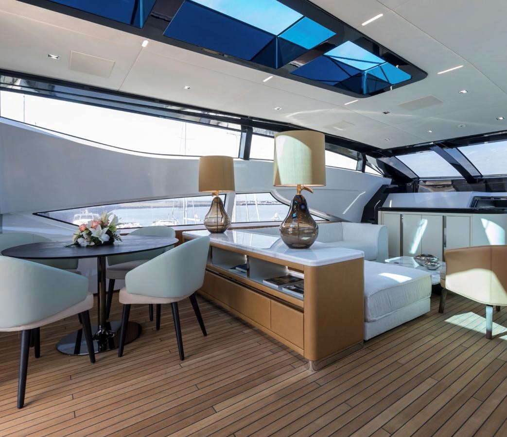 a room with a table and chairs aboard GOLDENEYE Yacht for Sale
