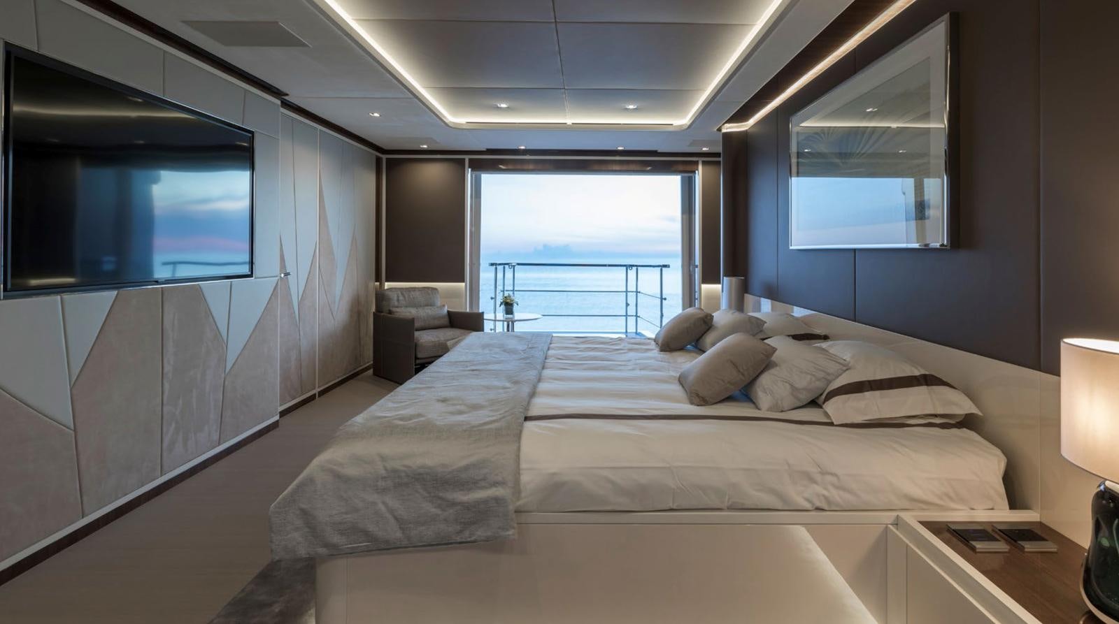 a large bed in a room aboard GOLDENEYE Yacht for Sale