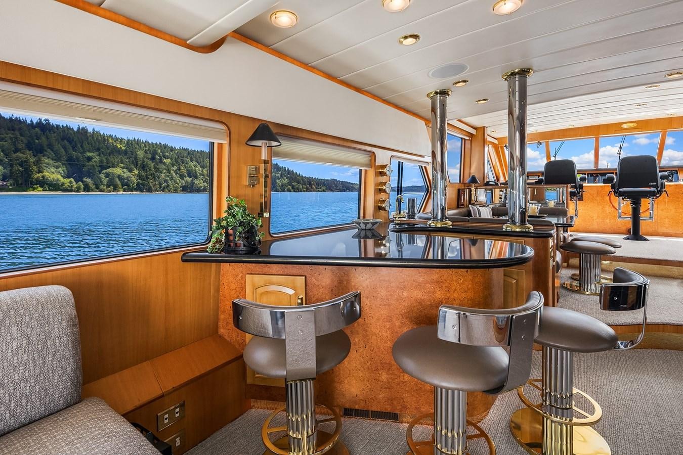 a large boat with a bar and chairs and tables aboard QUE SA-RAH SA-RAH Yacht for Sale
