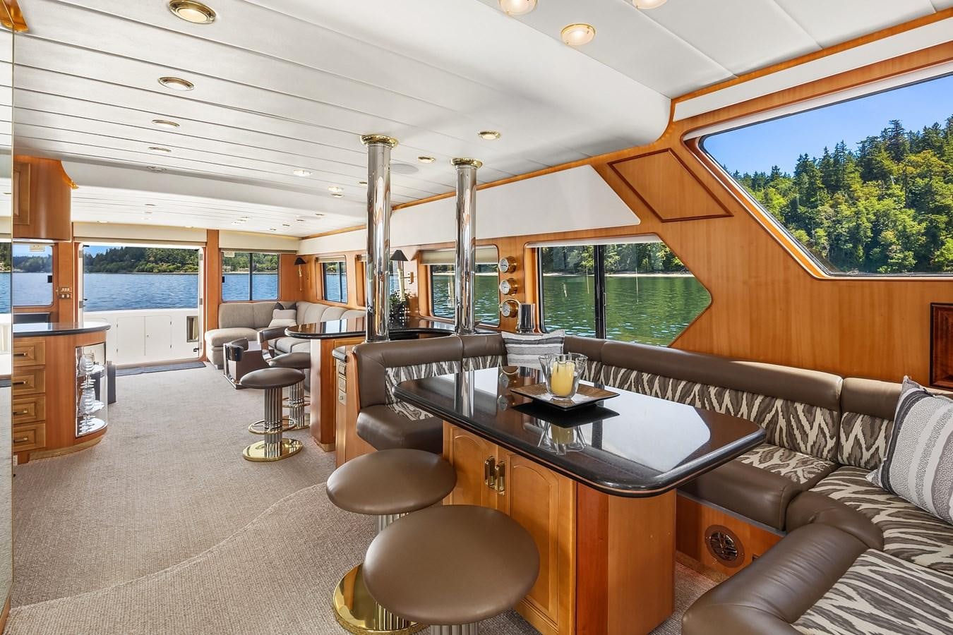 a living room with a table and chairs aboard QUE SA-RAH SA-RAH Yacht for Sale