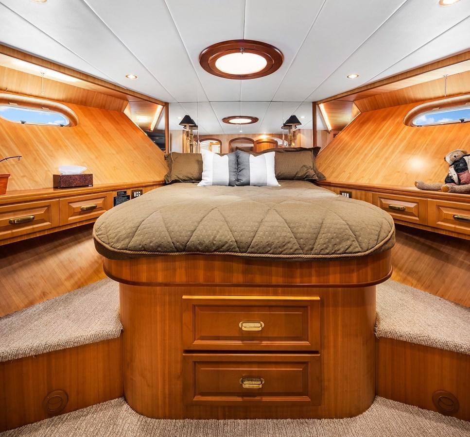 a cabin with a bed and a dresser aboard QUE SA-RAH SA-RAH Yacht for Sale