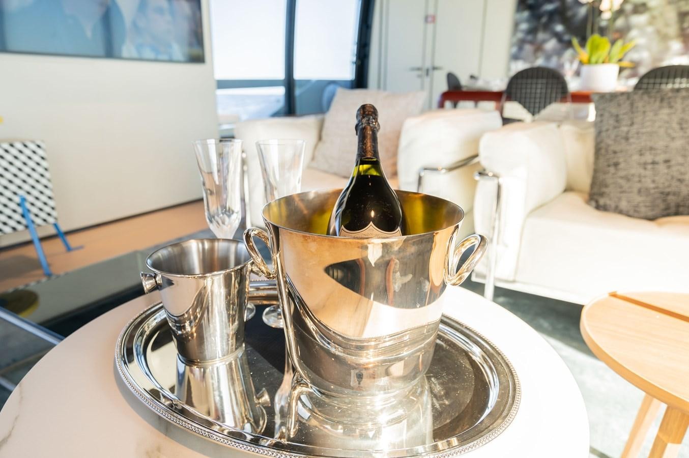 a glass of beer on a table aboard ANMAX Yacht for Sale