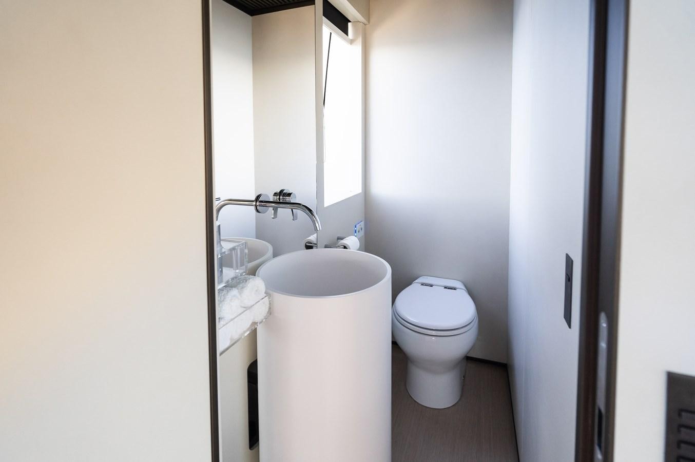 a bathroom with a sink toilet and a bathtub aboard ANMAX Yacht for Sale