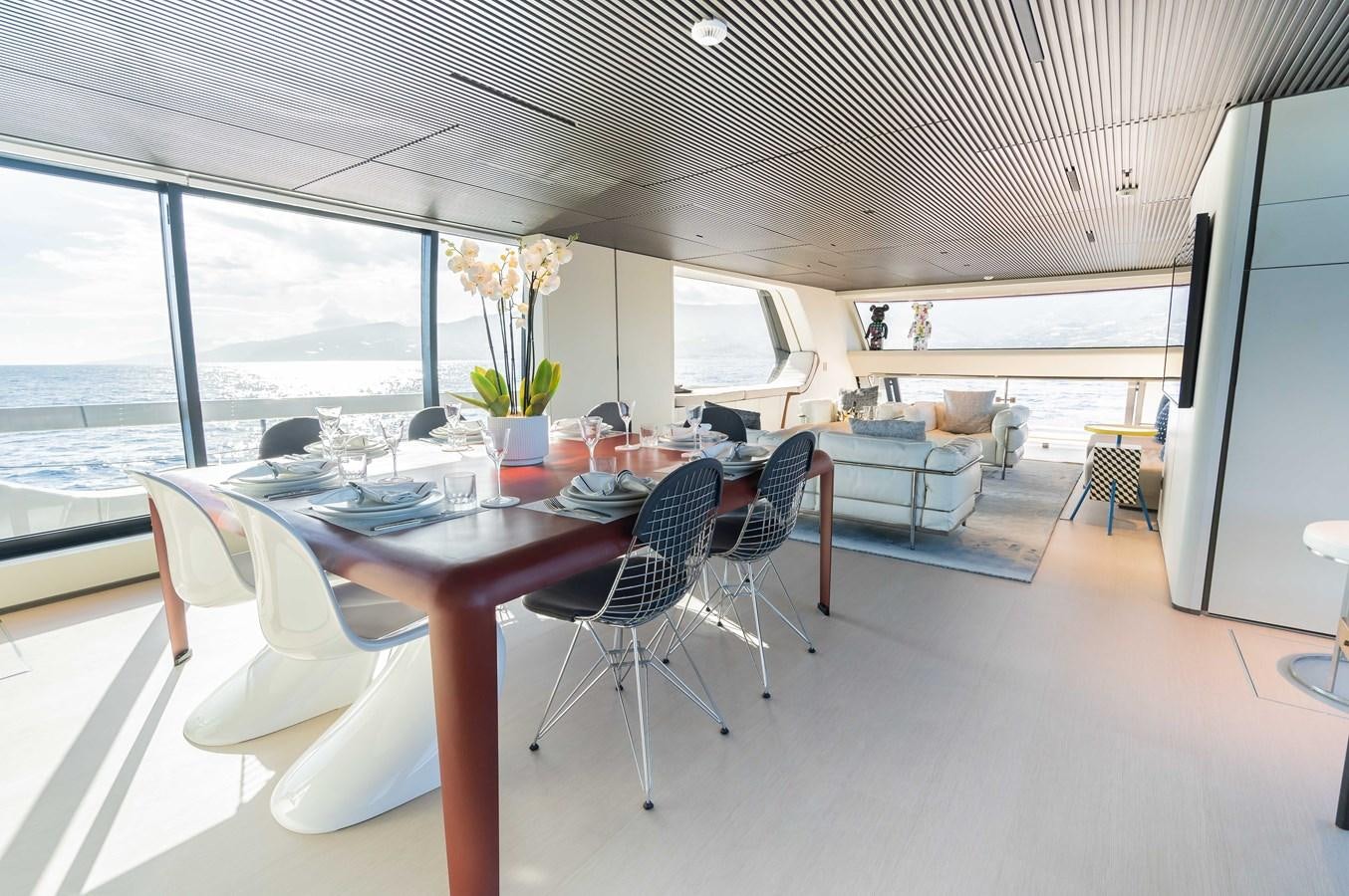 a large room with a table and chairs aboard ANMAX Yacht for Sale