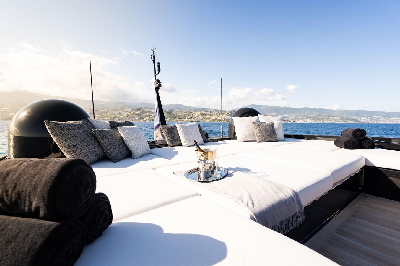 a bed with pillows and a statue on it aboard ANMAX Yacht for Sale