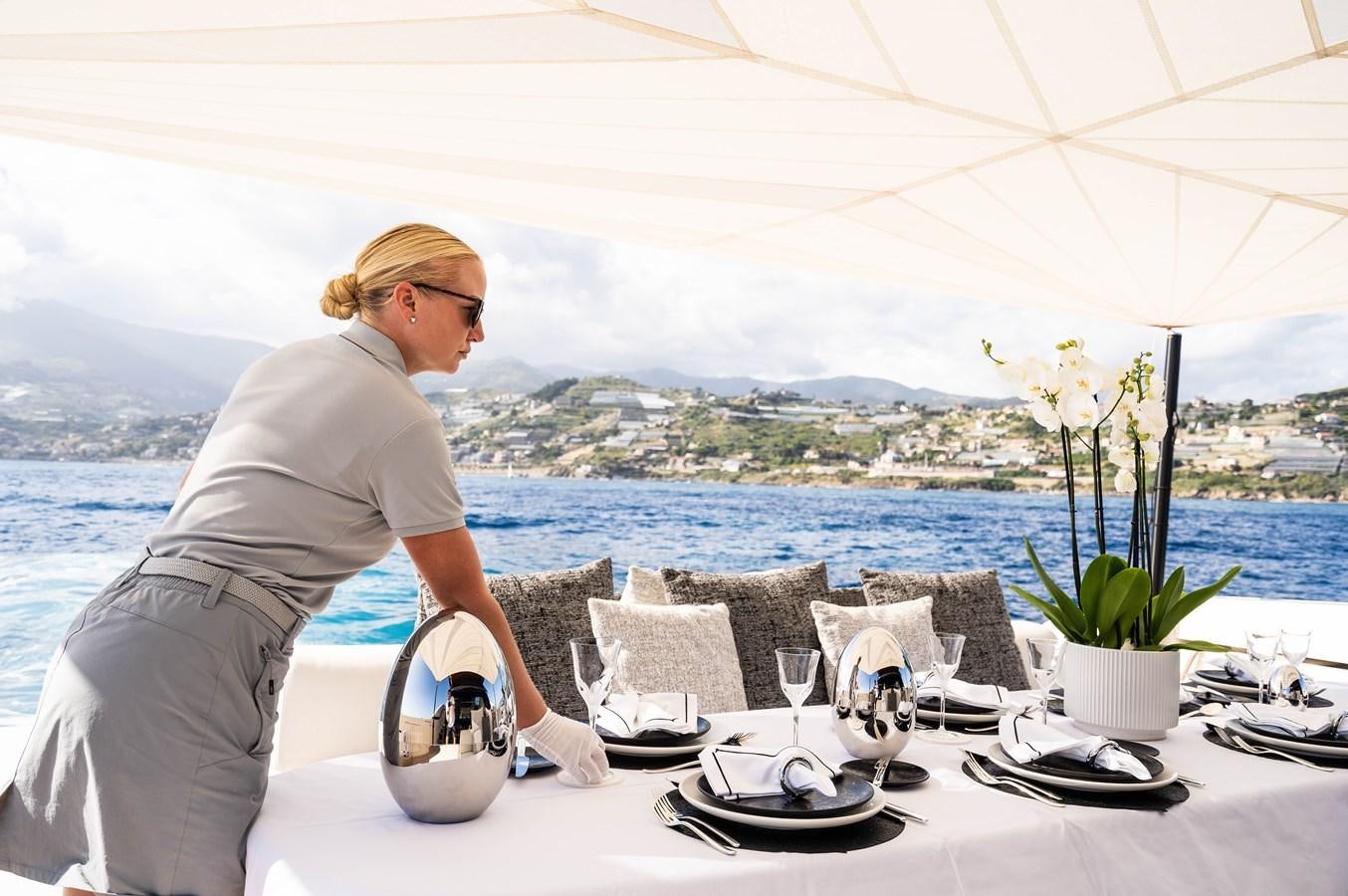 a person sitting at a table aboard ANMAX Yacht for Sale