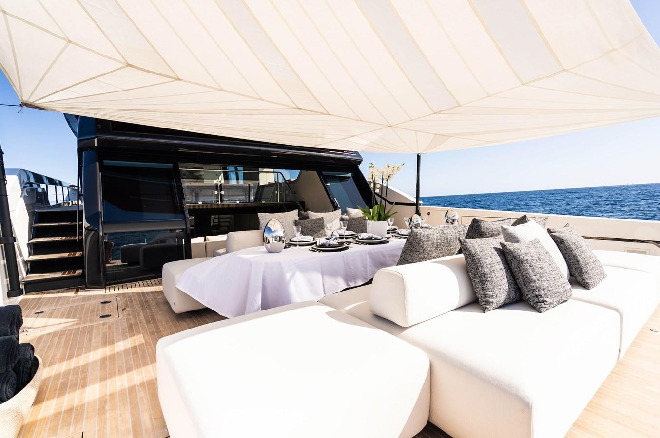 a room with a bed and a large patio with a large ocean aboard ANMAX Yacht for Sale