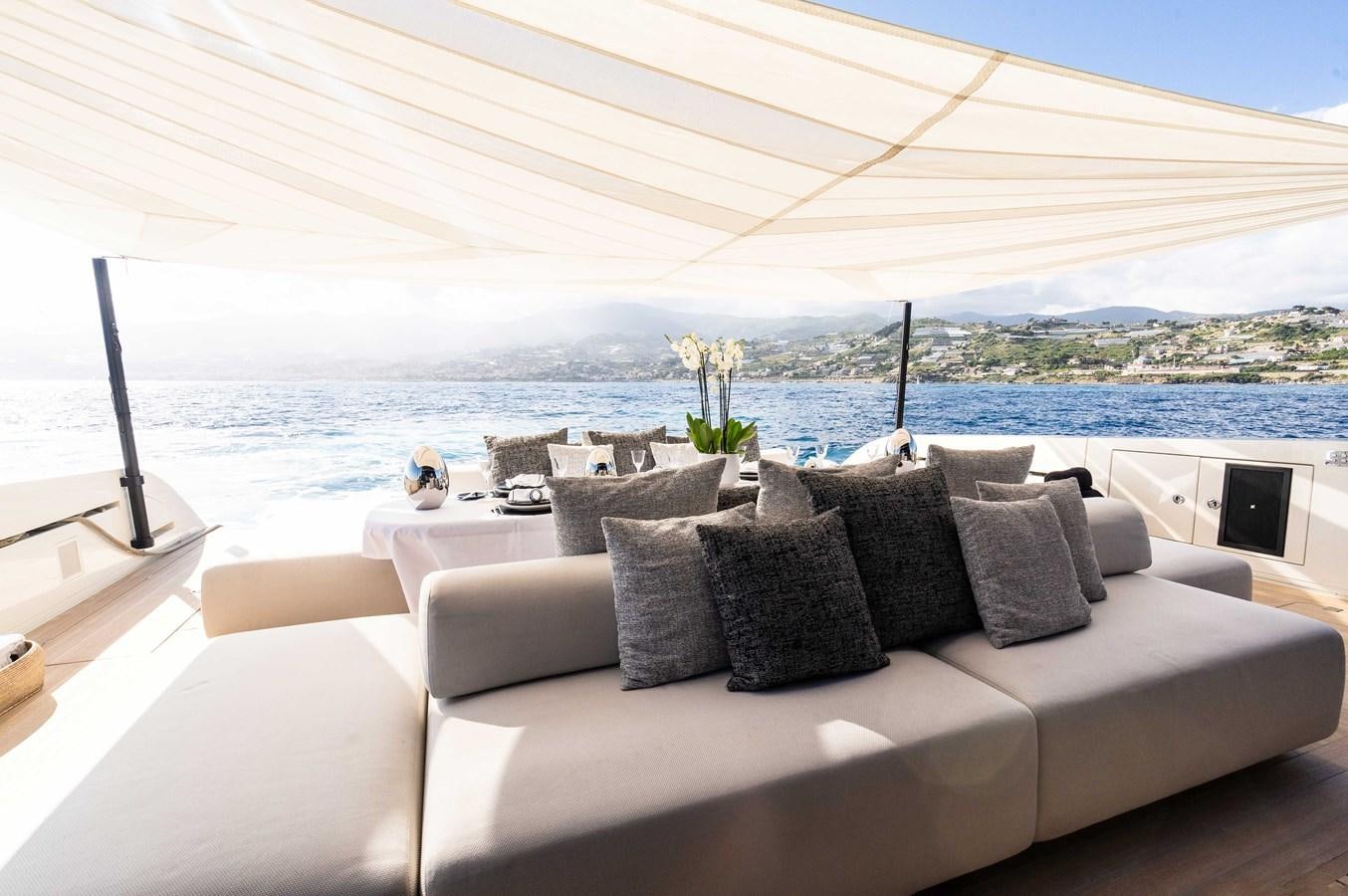 a couch with pillows on it aboard ANMAX Yacht for Sale