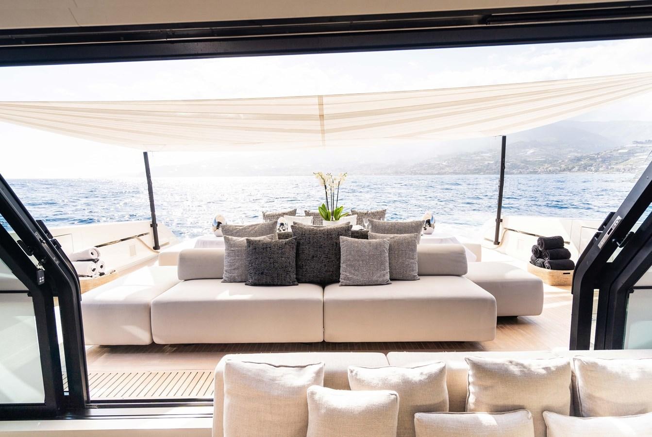 a couch and a table on a balcony aboard ANMAX Yacht for Sale