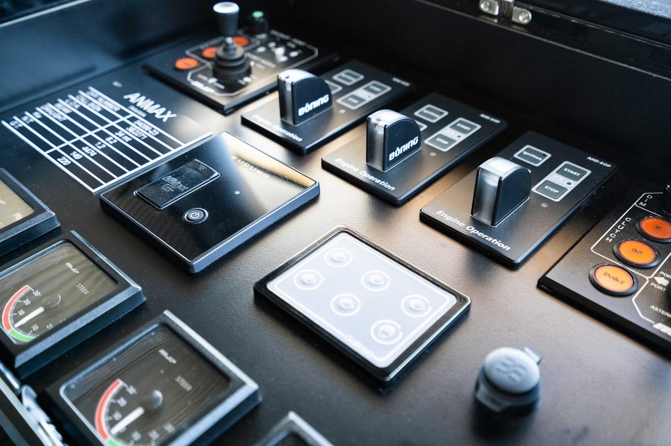 a group of electronic devices on a table aboard ANMAX Yacht for Sale