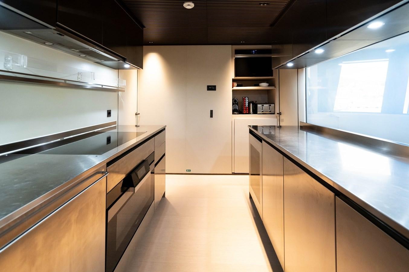 a kitchen with a large window aboard ANMAX Yacht for Sale