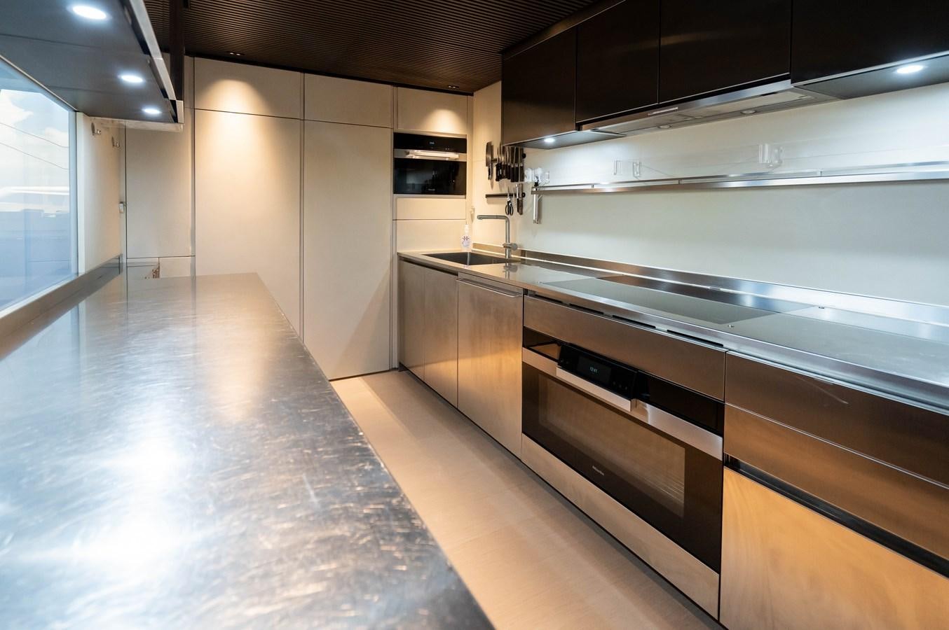 a large kitchen with stainless steel appliances aboard ANMAX Yacht for Sale