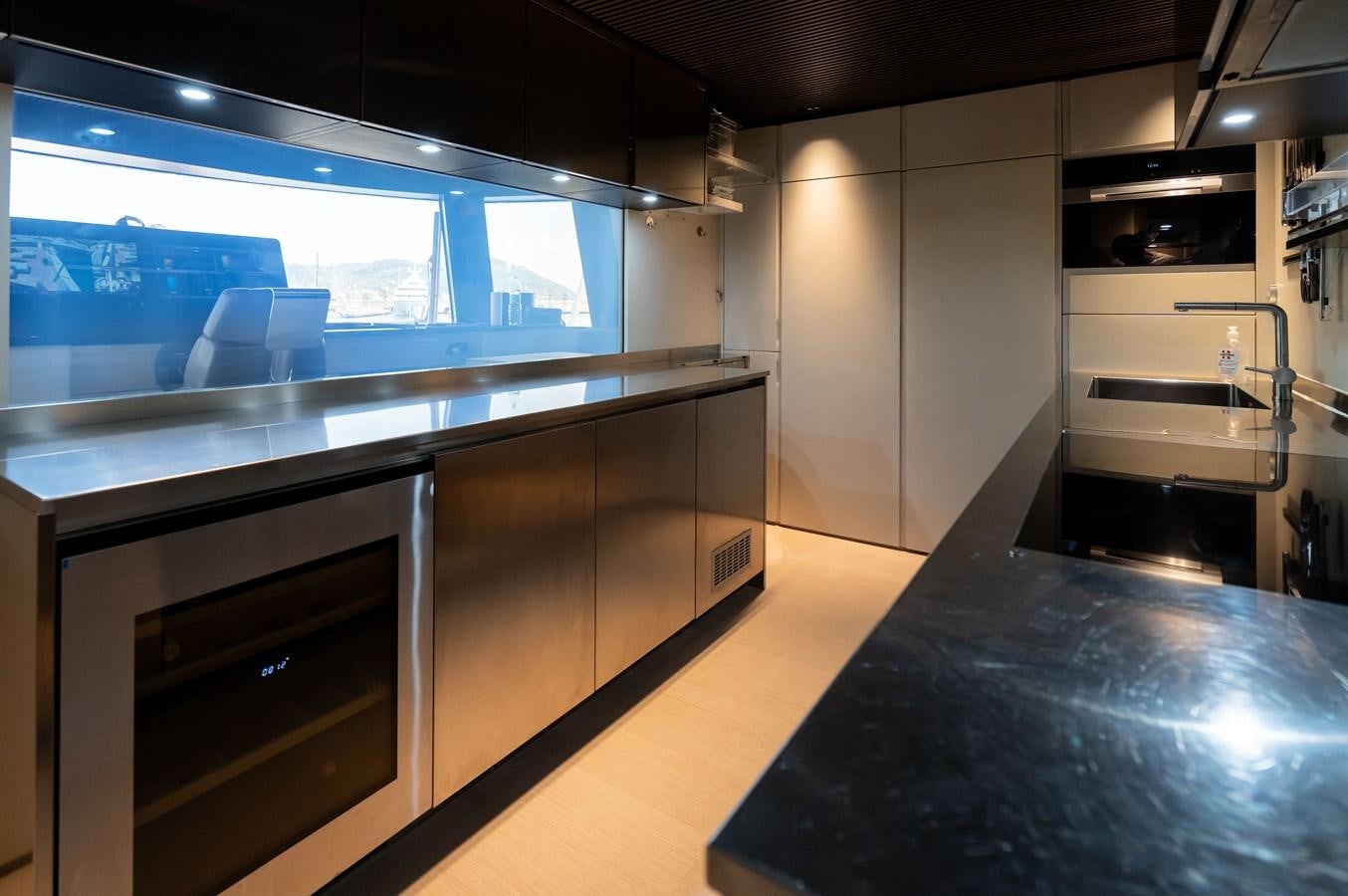 a kitchen with a large window aboard ANMAX Yacht for Sale