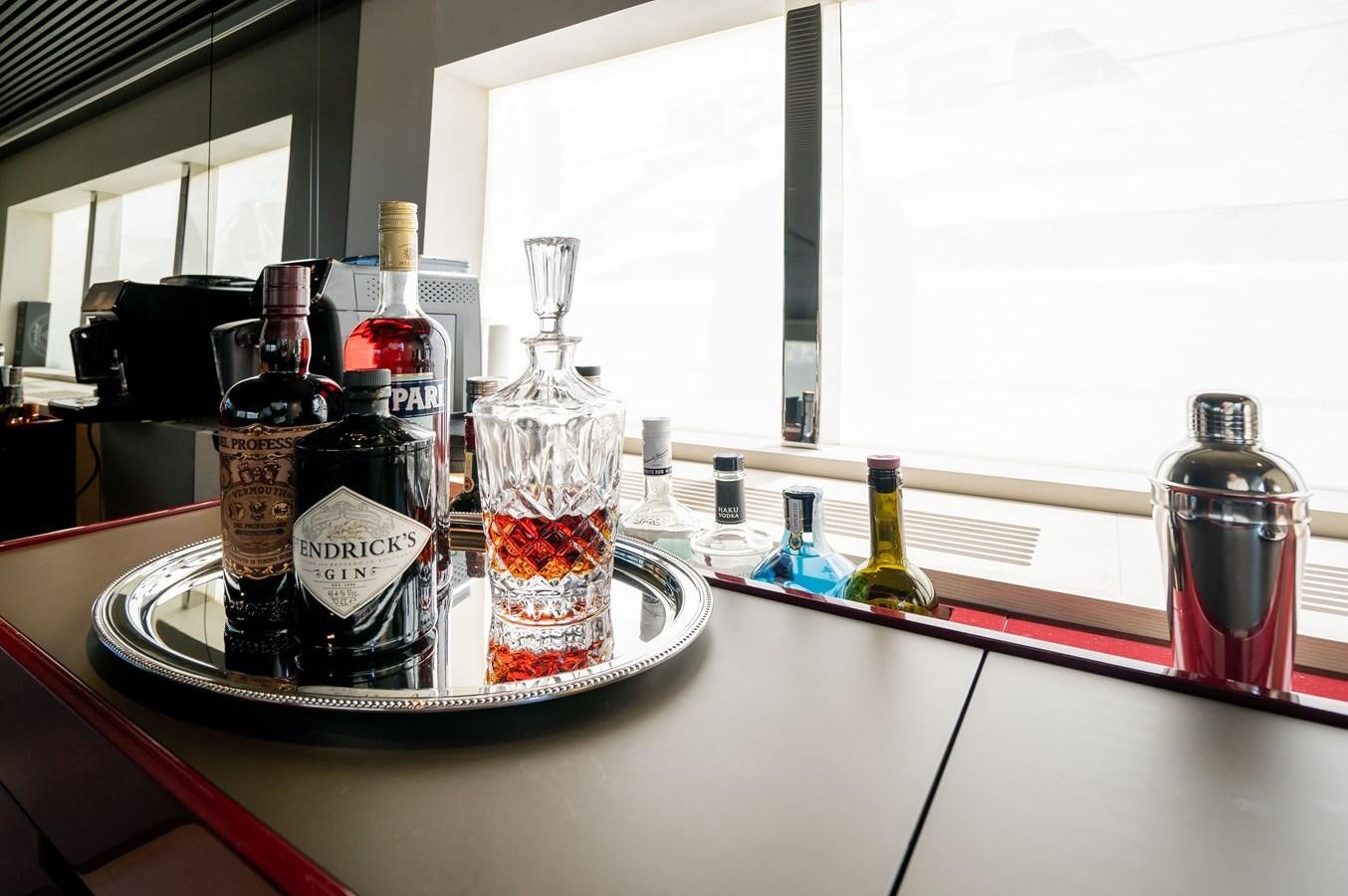 a bottle of liquor on a table aboard ANMAX Yacht for Sale