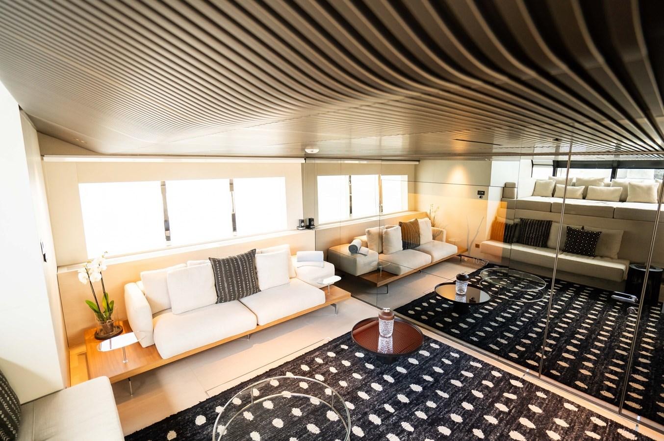a large room with a bed and a couch aboard ANMAX Yacht for Sale