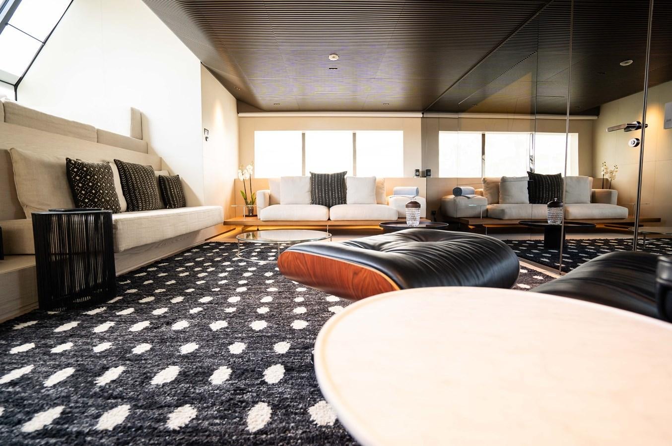 a room with a couch and a table aboard ANMAX Yacht for Sale