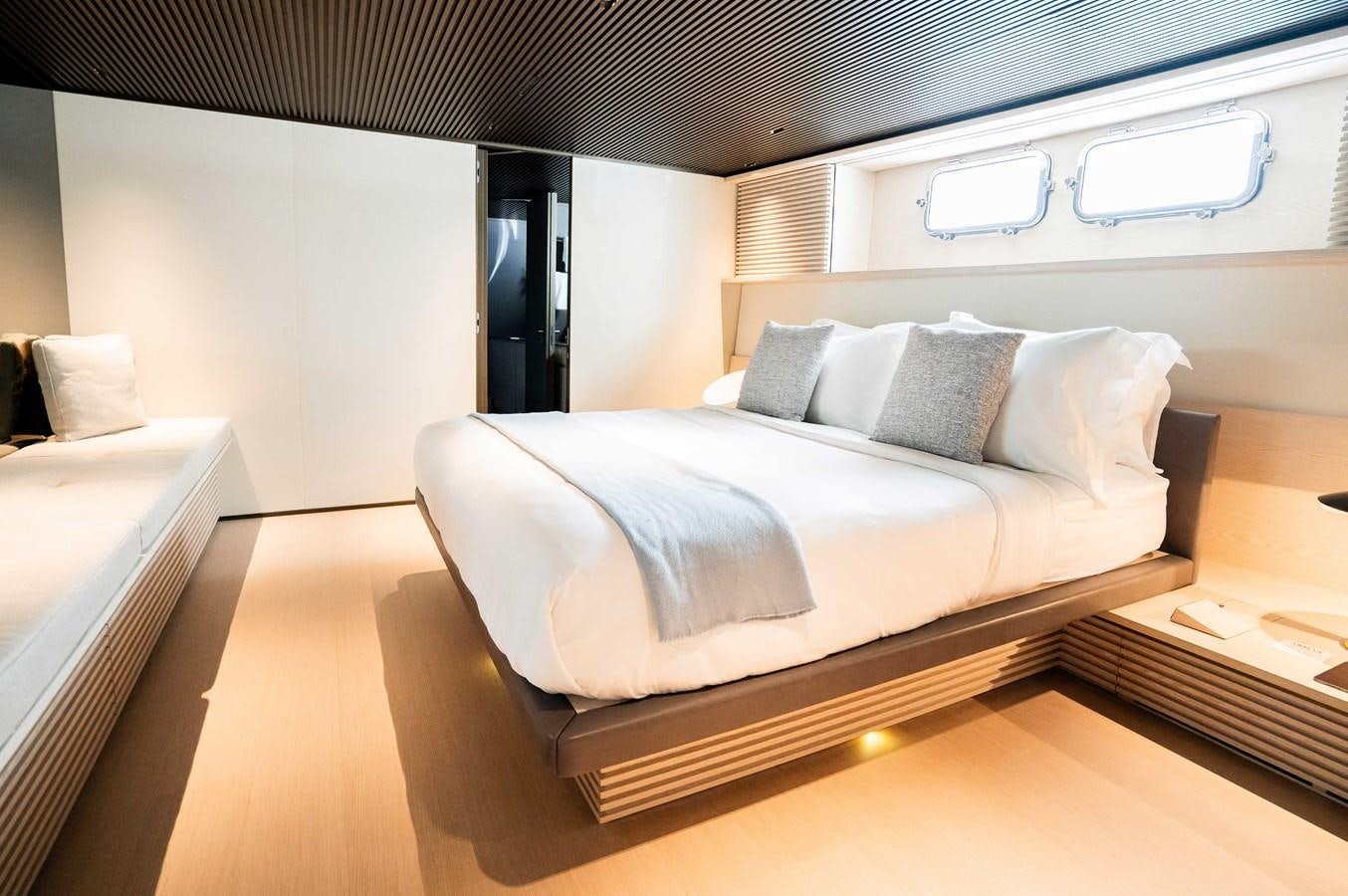 a bed with white sheets aboard ANMAX Yacht for Sale