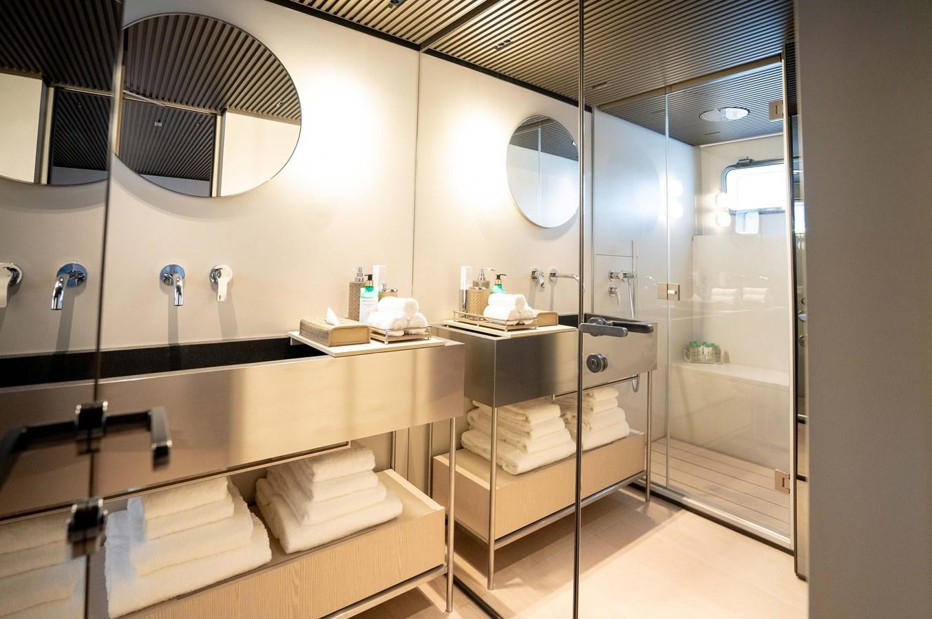 a bathroom with a large mirror aboard ANMAX Yacht for Sale