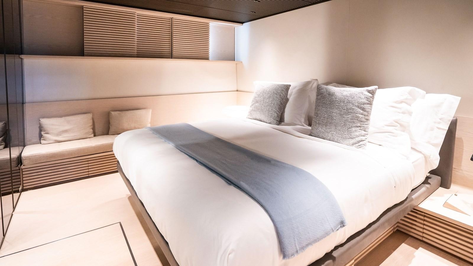 a bed with a blue sheet aboard ANMAX Yacht for Sale