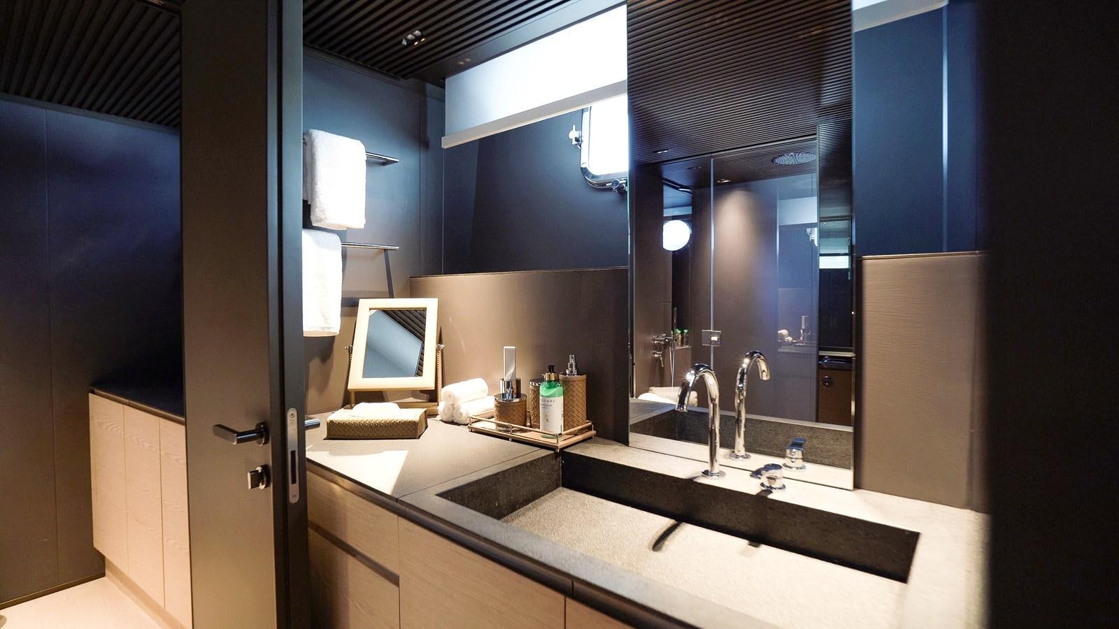 a bathroom with a large mirror aboard ANMAX Yacht for Sale