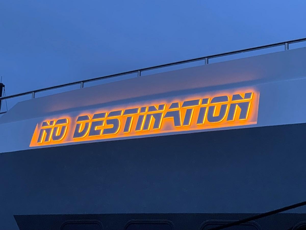 a sign on a building aboard NO DESTINATION Yacht for Sale