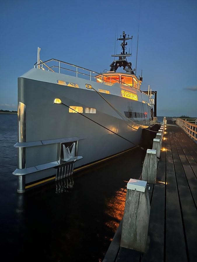 a large ship docked aboard NO DESTINATION Yacht for Sale