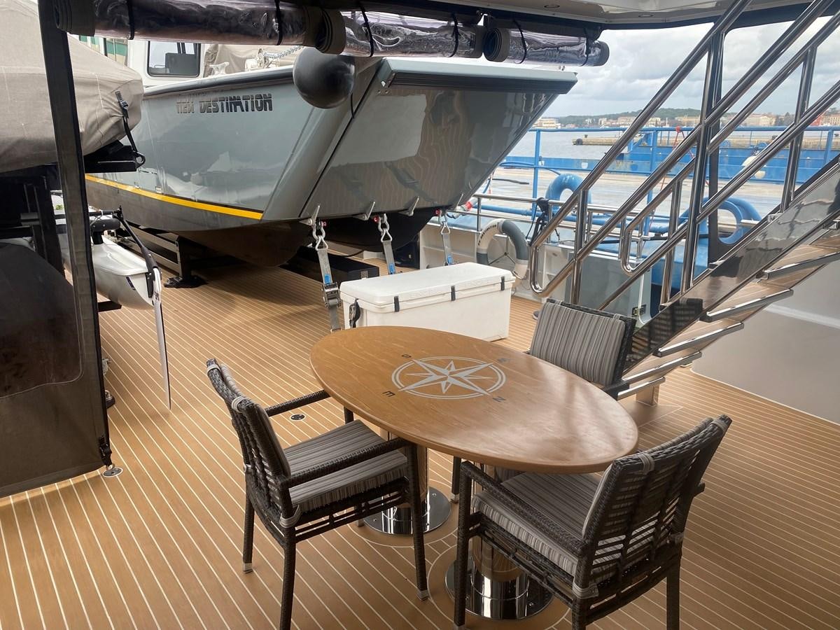 a table and chairs in a room aboard NO DESTINATION Yacht for Sale
