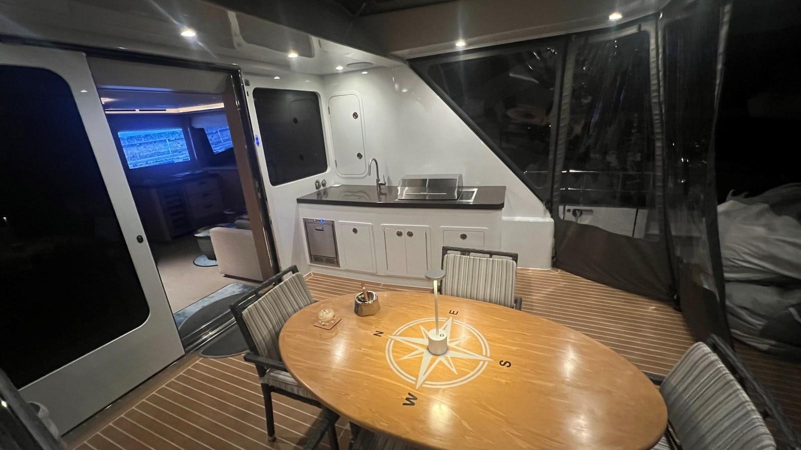 a room with a table and chairs aboard NO DESTINATION Yacht for Sale