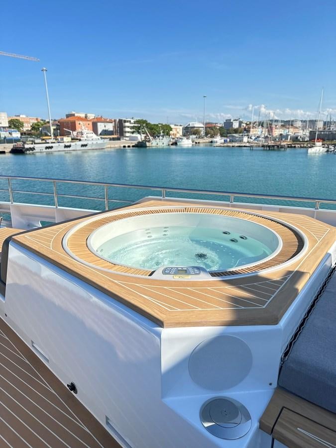 a pool on a deck overlooking a city aboard NO DESTINATION Yacht for Sale