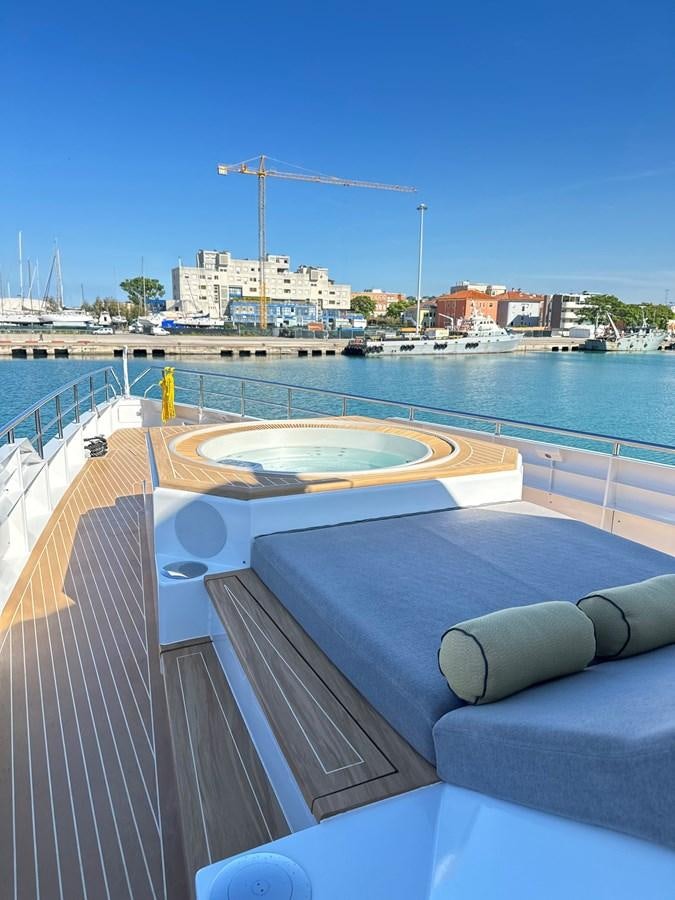 a pool with a wheel and a ferris wheel in the background aboard NO DESTINATION Yacht for Sale