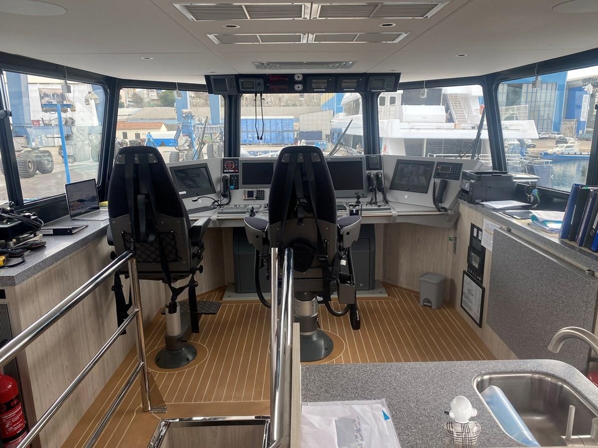 a room with a desk and chairs aboard NO DESTINATION Yacht for Sale