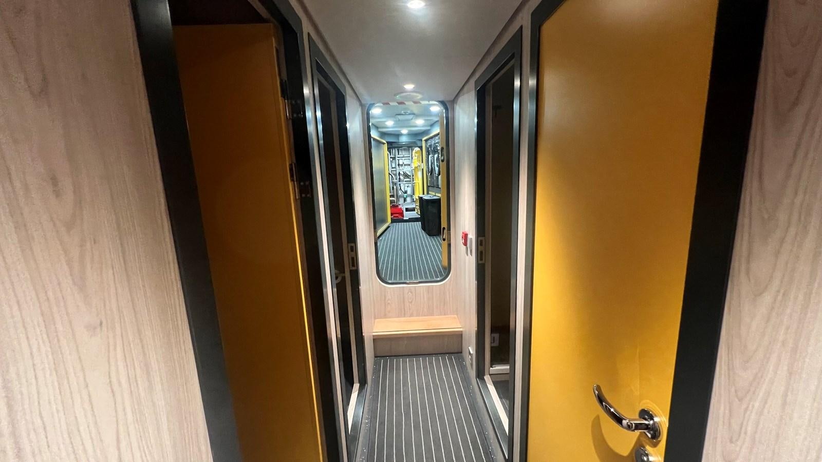 a hallway with doors aboard NO DESTINATION Yacht for Sale