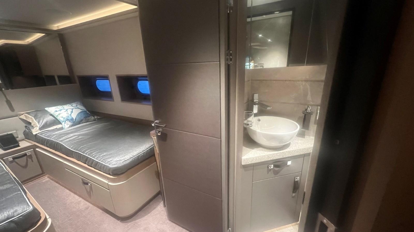 a bathroom with a sink and a bed aboard NO DESTINATION Yacht for Sale