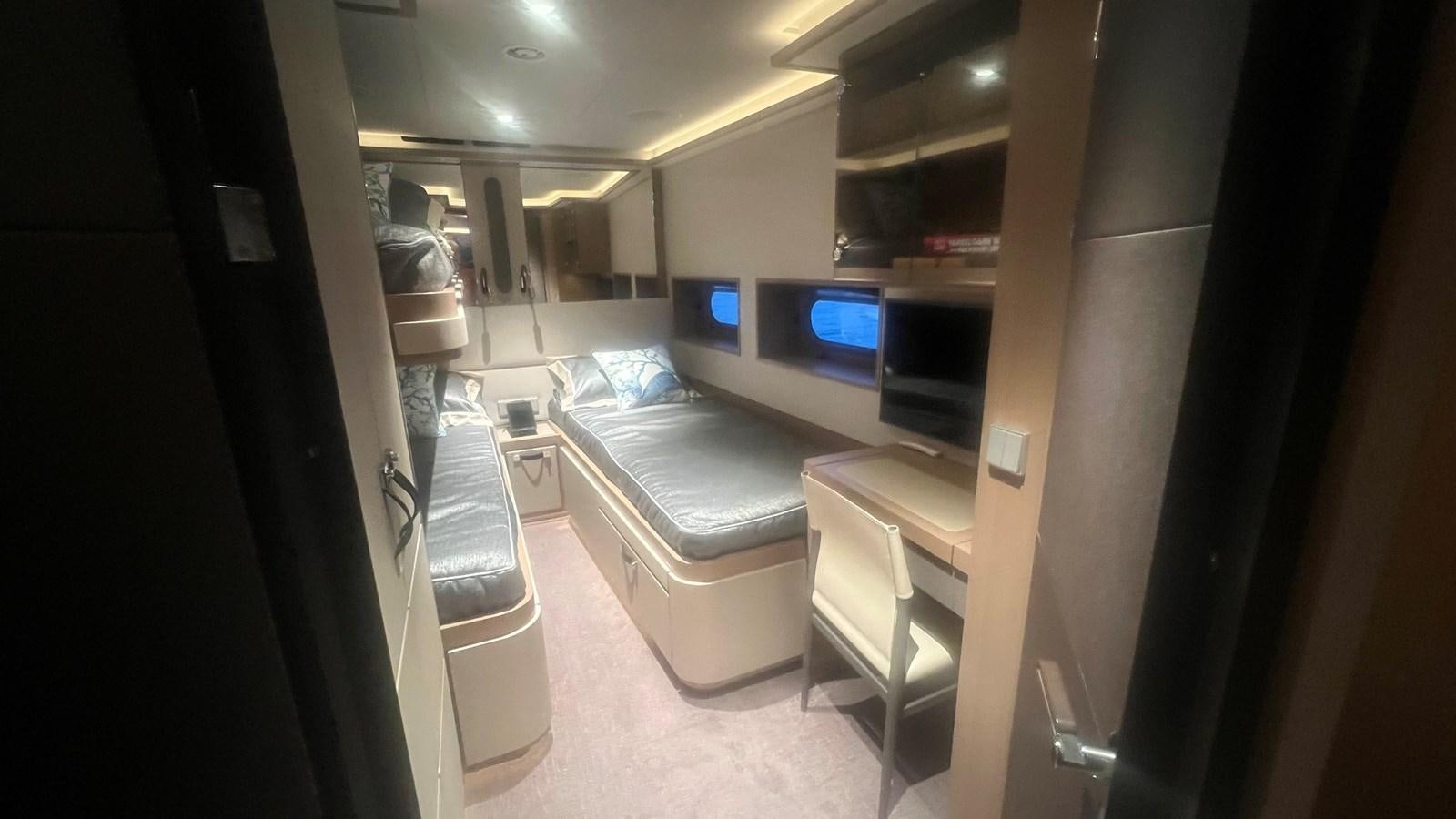 a room with a bed and a tv aboard NO DESTINATION Yacht for Sale