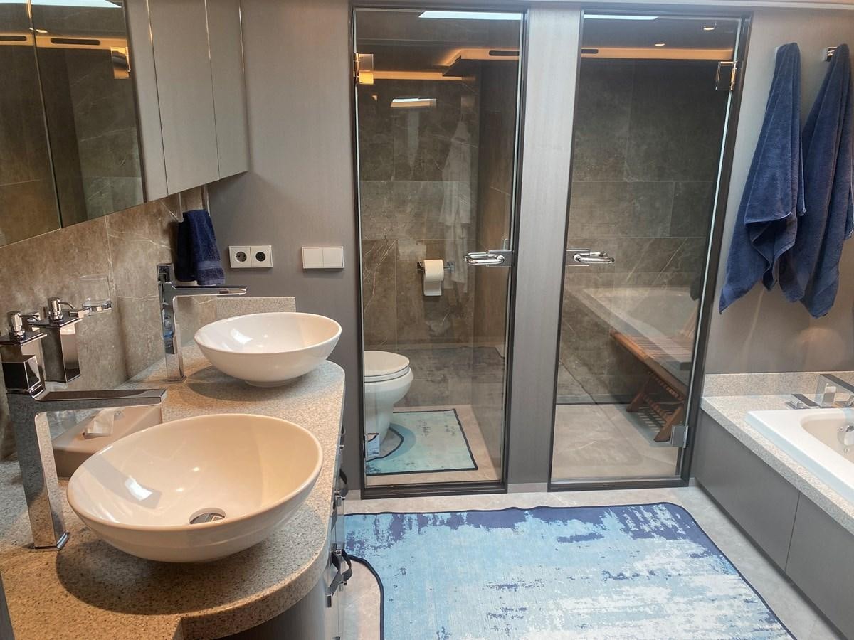 a bathroom with sinks and mirrors aboard NO DESTINATION Yacht for Sale