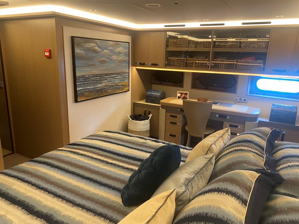 a room with a bed and a desk aboard NO DESTINATION Yacht for Sale