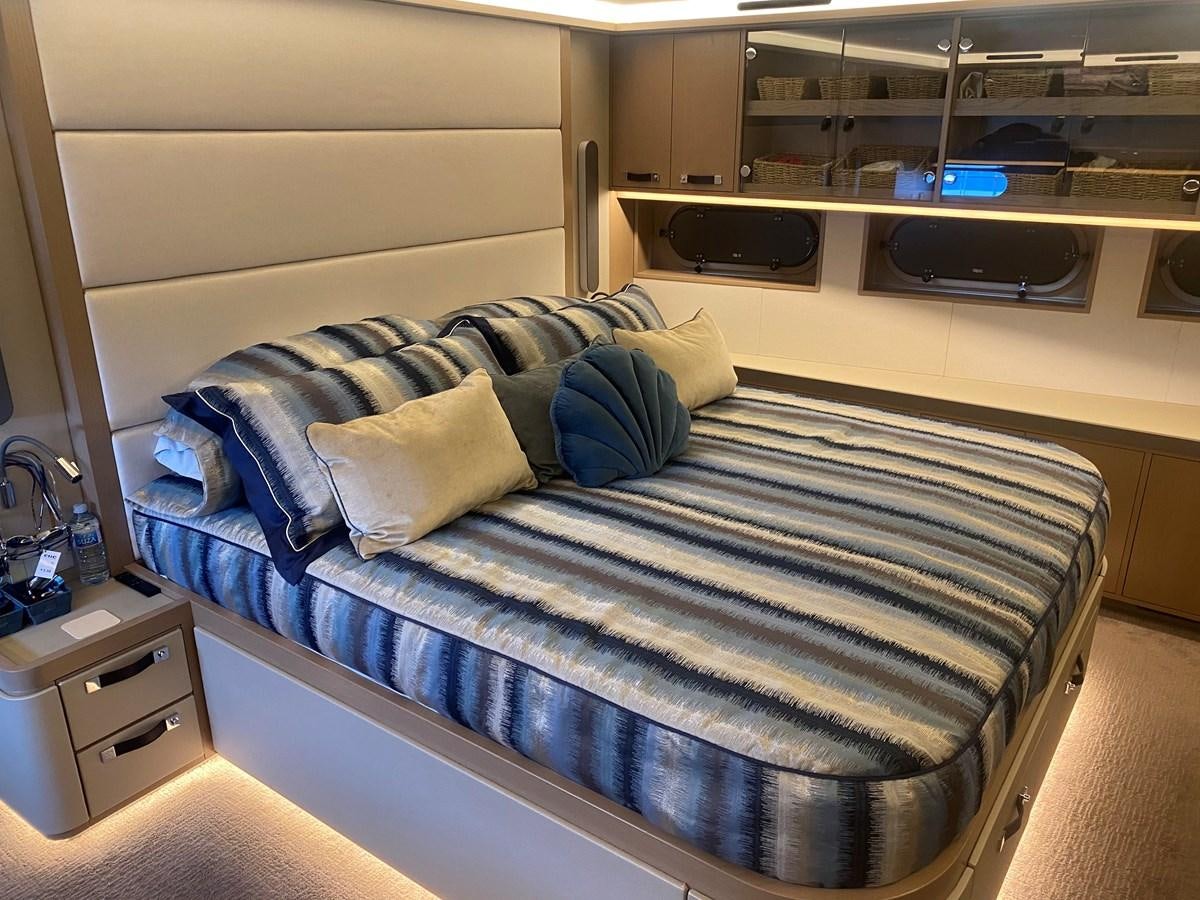 a bed with a blue comforter aboard NO DESTINATION Yacht for Sale