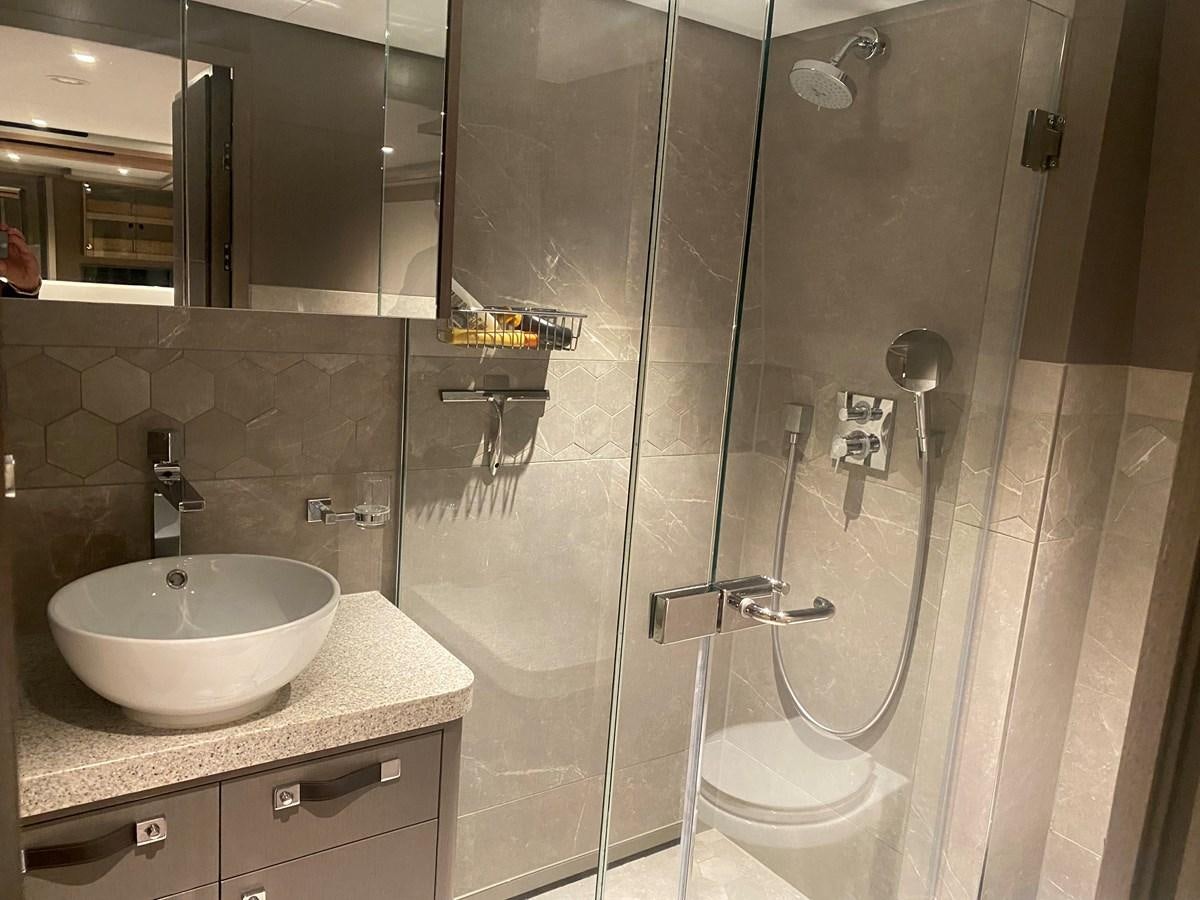 a bathroom with a glass shower aboard NO DESTINATION Yacht for Sale