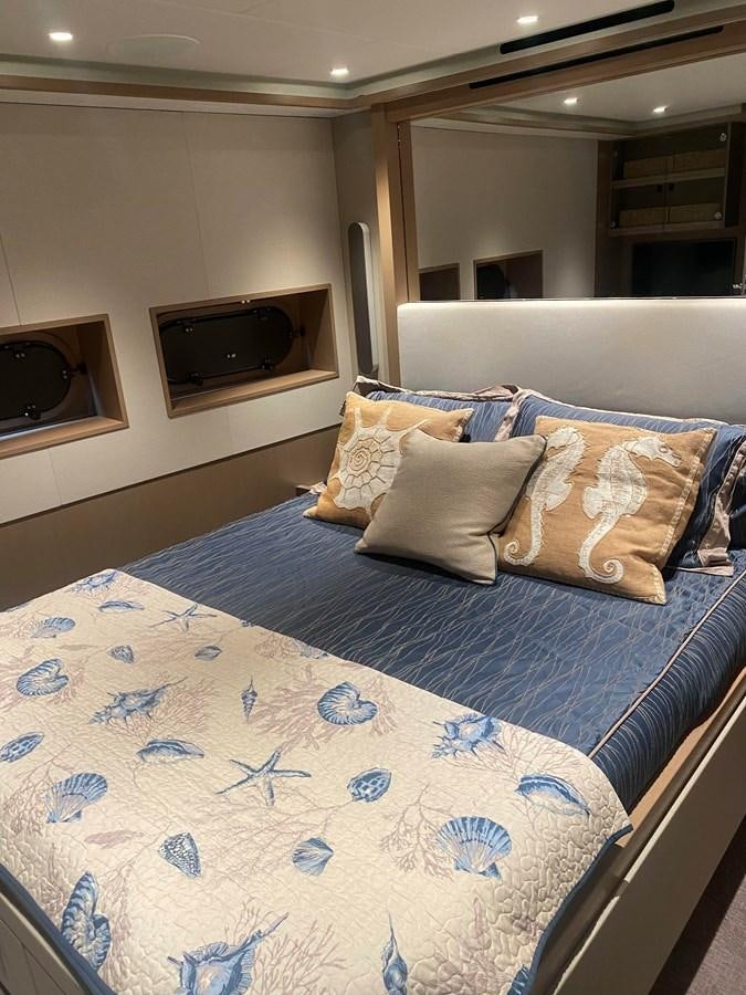 a bed with blue sheets aboard NO DESTINATION Yacht for Sale