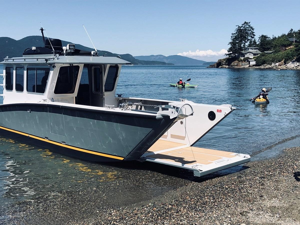 a boat on the shore aboard NO DESTINATION Yacht for Sale