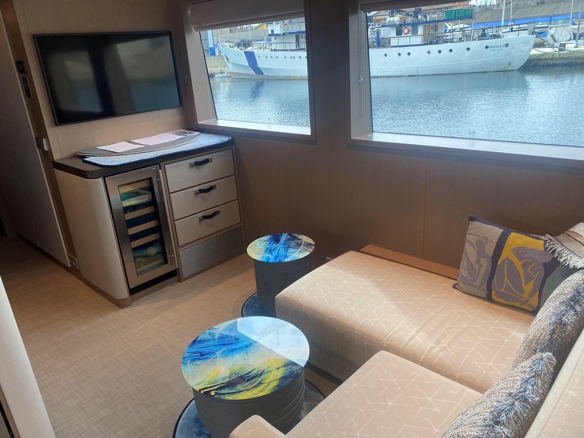 a living room with a couch and a tv aboard NO DESTINATION Yacht for Sale
